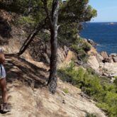 Groupe de randonneurs se dirigeant sur un sentier le long de la mer en Costa Brava
