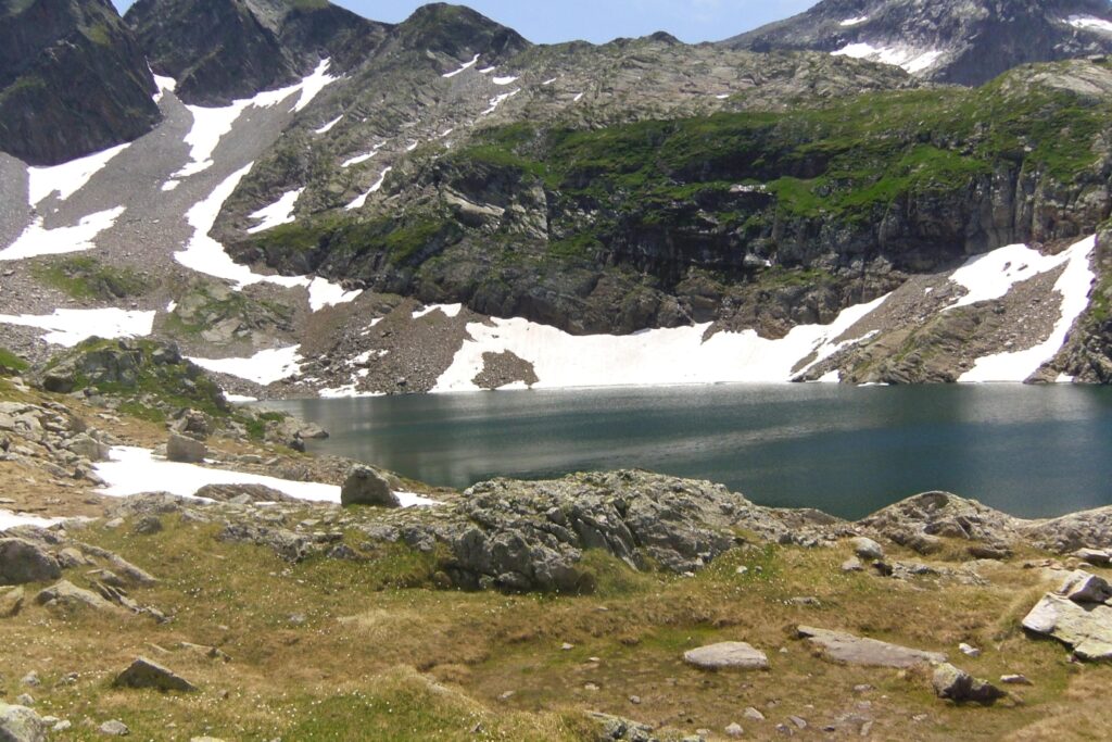 Lac de montagne avec en arrière-plan des montagnes couvertes de neige