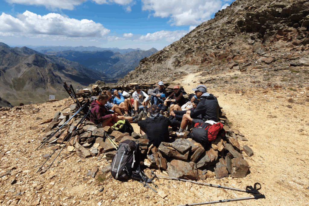 Groupe de randonneurs réunis face aux montagnes des hauts sommets d'Andorre.
