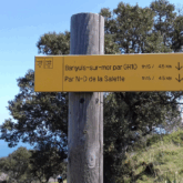 Paysage montagnard avec un panneau indiquant les différents sentiers possibles sur le trajet du GR10