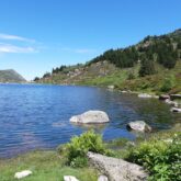 Lac de montagne avec paysage ensoleillé encadré de sommets