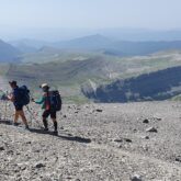 Groupe de randonneurs sur un sentier de cailloux avec leur guide