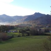 Paysage du Pays basque avec des sommets en fond et une vallée verdoyante au premier plan
