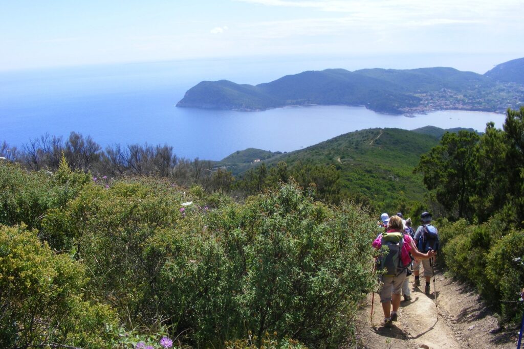 Groupe de randonneurs sur un sentier de montagne qui descend.