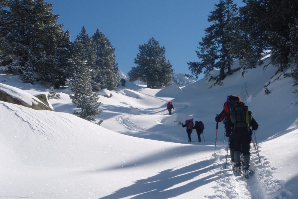 Groupe de randonneurs sur un sentier avec leur guide en hiver à travers la neige dans les encartais