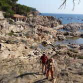 Groupe de randonneurs qui marchent dans les rochers en Costa Brava