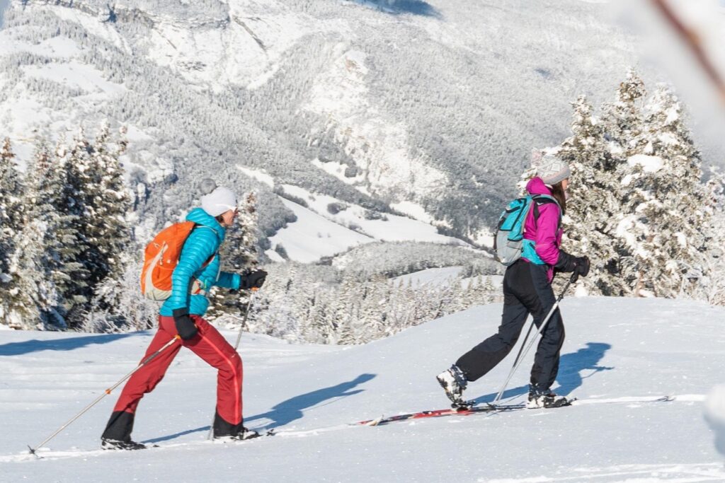 Deux randonneurs sur un sentier de randonnée accompagnés d'un guide en ski de fond dans le Vercors