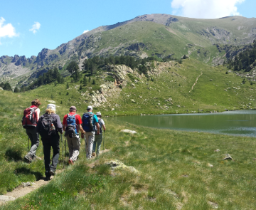 Groupe de randonneurs sur un sentier se dirigeant vers un lac de montagne entre Cauterets et Luchon