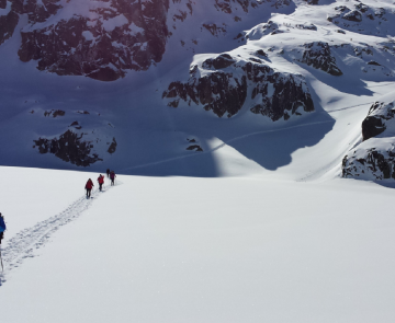 Groupe de randonneurs sur un sentier de randonnée tracé à travers la neige dans les encantats