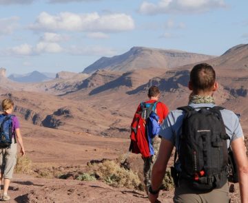 Groupe de randonneurs qui regardent les montagnes désertiques du djebel Saghro devant eux