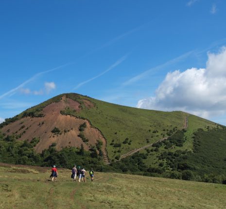 Paysage de montagne dans le massif central avec un groupe de randonneurs sur un sentier